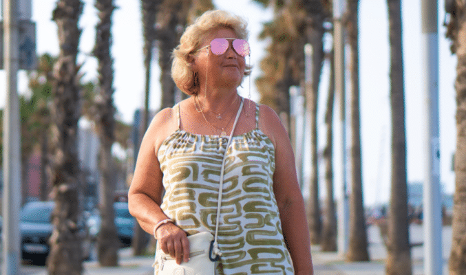 Woman walking w pink sun glasses